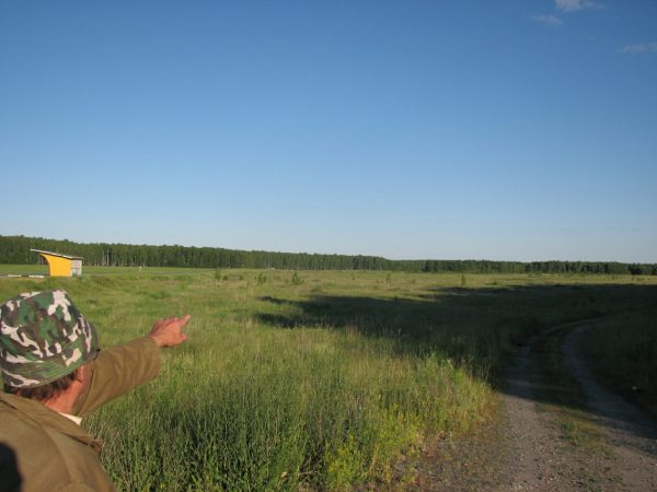 Nikolai Ivanovich points to the alleged landing site of a UFO. In 1990, several eyewitnesses reported the landing of a flying saucer